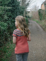 Girl wearing crocheted sweater on country road