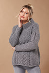 Young woman wearing grey knitted sweater