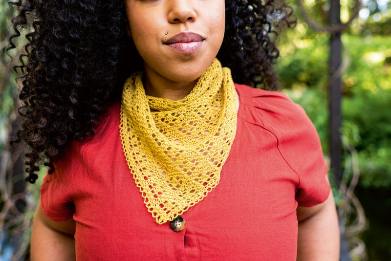 Young woman outside wearing small yellow knitted cowl