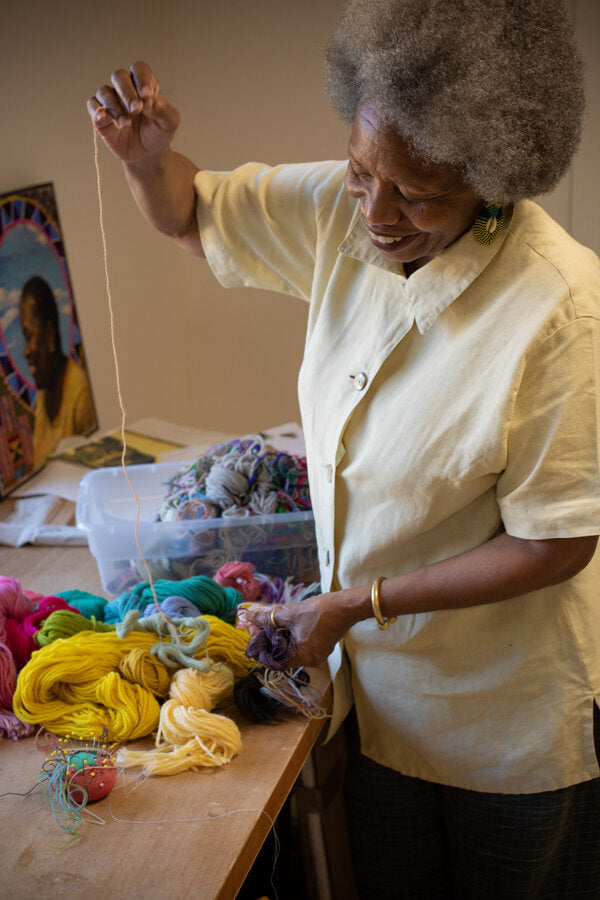 Older woman smiling with yarn