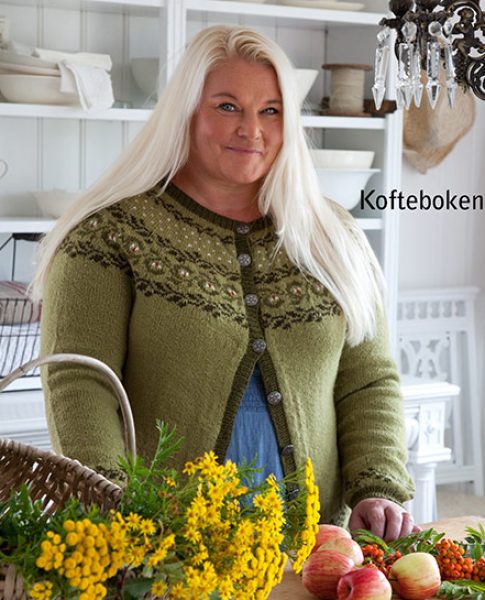 Smiling woman in kitchen wearing knitted sweater