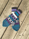 Colorful mittens on a wooden deck