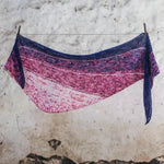 Blue and pink coloured knitted shawl hanging on clothesline
