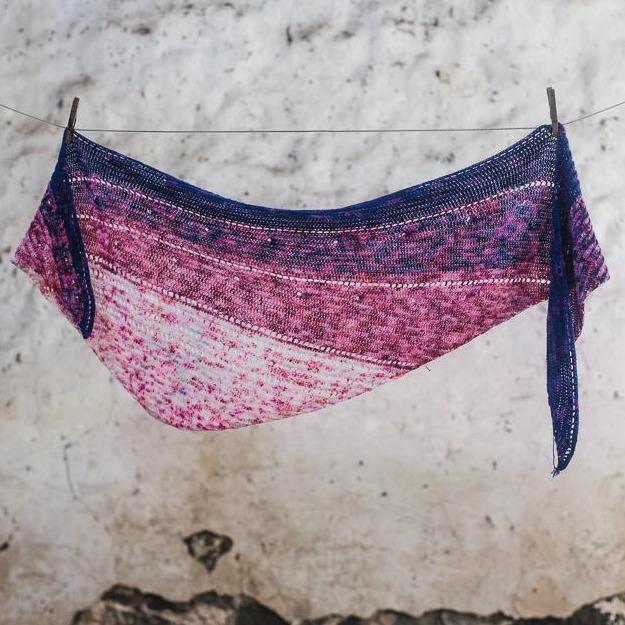 Blue and pink coloured knitted shawl hanging on clothesline