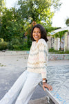 Smiling woman wearing knitted sweater outdoors