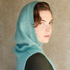 Young woman wearinng teal knitte cowl