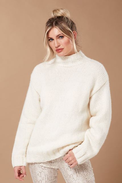 Young woman wearing white knitted sweater