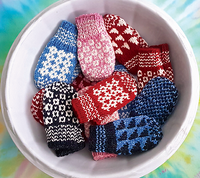 Colourful mittens in a white bowl
