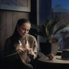 Woman knitting with Lumos Knitting Light