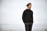 young man in knitted sweater outdoors
