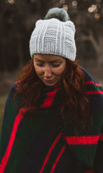 Young woman in nature wearing knitted hat and wrap