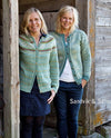 Two women smiing wearing blue knitted sweaters