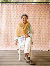 Woman sitting on chair with knitted shawl