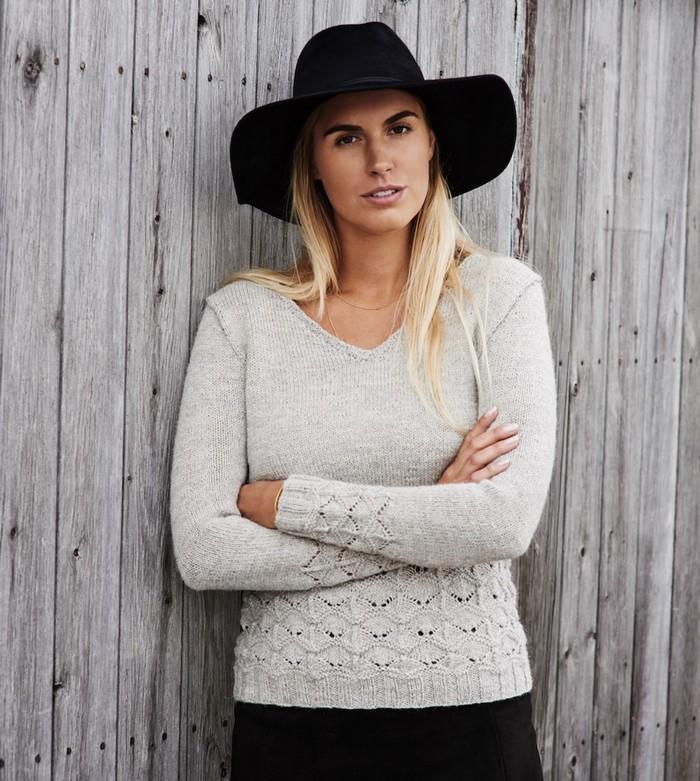 Woman wearing knitted sweater and cowboy hat