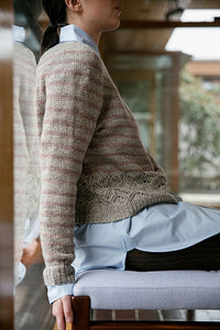 Woman in knitted sweater sitting on chair