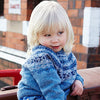 Young girl outside wearing bright blue sweater