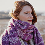 Red-haired woman outdoors wearing purple scarf