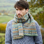 Man wearing knitted sweater and scarf