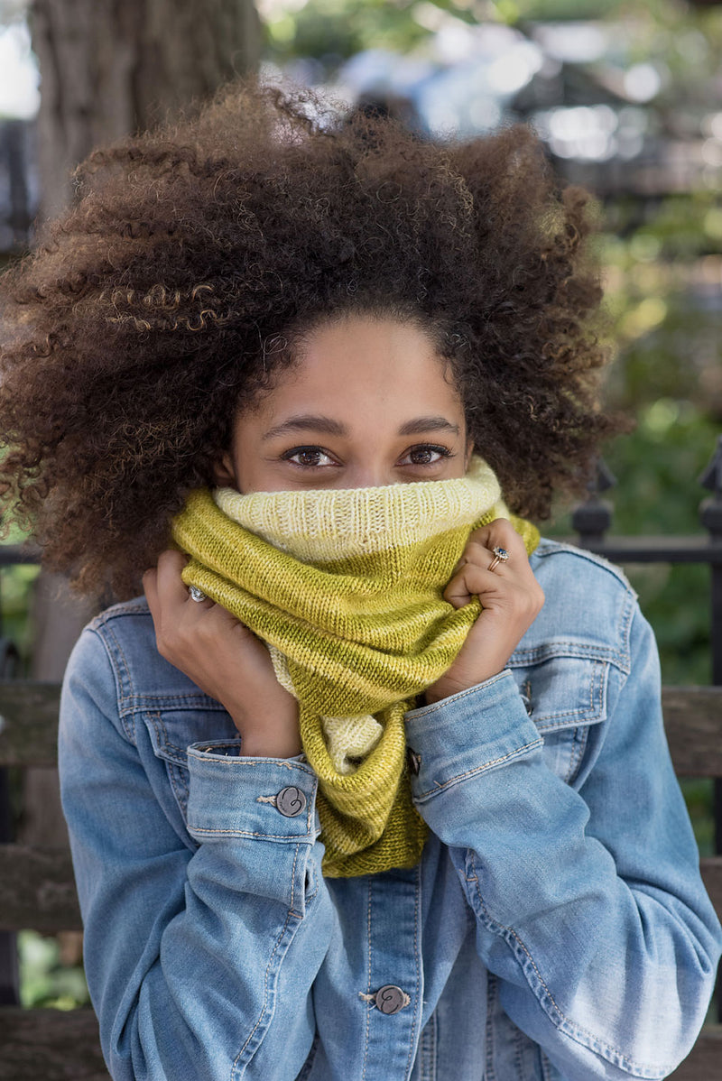 Young lady outside wearing knitted scarf and denim shirt