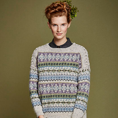 Woman wearing knitted sweater with green ivy in her hair
